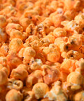Close up of orange buffalo cheddar gourmet popcorn from Popped! Republic