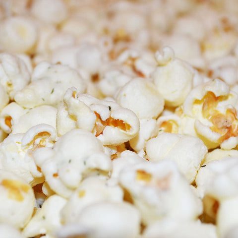 Close-up of savory air popped dill pickle flavored popcorn from Popped! Republic