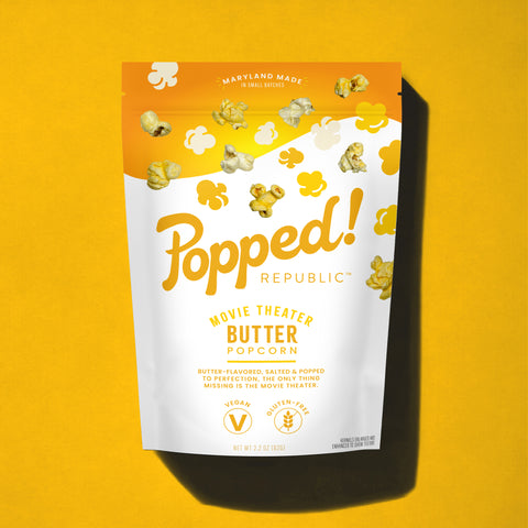 Stand up pouch of gourmet Movie Theater Butter popcorn on a yellow background