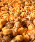 Close-up of gourmet caramel and orange cheese popcorn from Popped! Republic