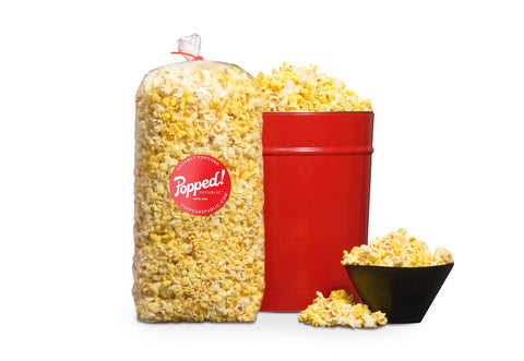 Red tin and an extra large bulk bag of Movie Theater Butter seasoned specialty popcorn