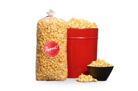 red bucket and an extra large bulk bag of Old Bay seasoned specialty popcorn