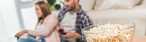 couple at home with healthy popcorn snack