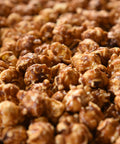 close up of gourmet artisanal Caramel-glazed popcorn drizzled with rich dark chocolate
