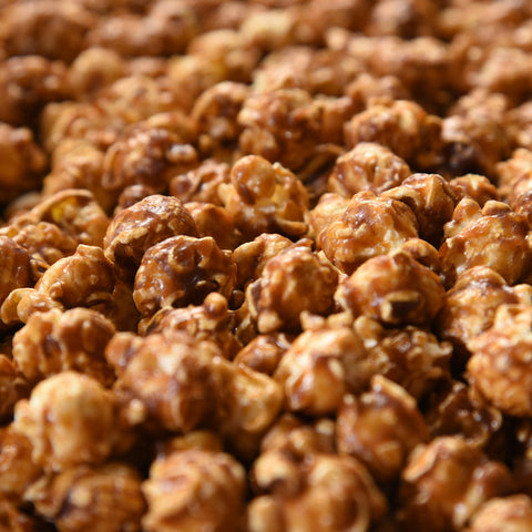 close up of gourmet artisanal Caramel-glazed popcorn drizzled with rich dark chocolate