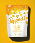 Stand up pouch of gourmet Movie Theater Butter popcorn on a yellow background