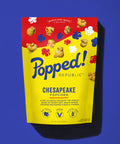 Stand up pouch of Gourmet Chesapeake style popcorn on a blue background