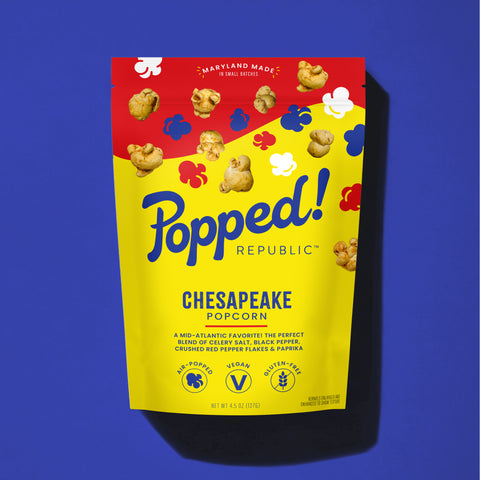 Stand up pouch of Gourmet Chesapeake style popcorn on a blue background