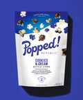 Stand up pouch of Cookies and Cream kettle corn on a blue background