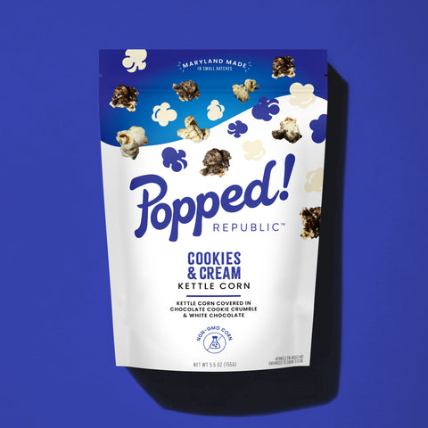 Stand up pouch of Cookies and Cream kettle corn on a blue background