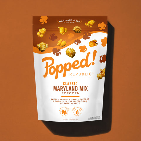 Stand up pouch of Classic Maryland Mixl popcorn on a light brown background