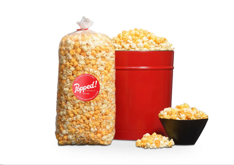 Red tin and an extra large bulk bag of Buffalo Cheddar seasoned specialty popcorn