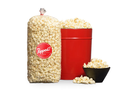 Red bucket and an extra large bulk bag of Gourmet savory ranch flavored popcorn from Popped! Republic