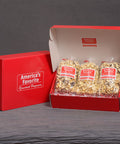 Popped! Republic Red gift box holding 3 artisan chocolate popcorn flavors: dark chocolate, cookies & cream, caramel drizzle 
